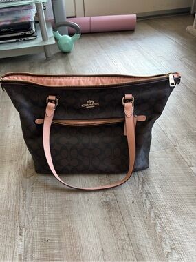 Coach Gallery Tote features signature dark brown canvas with peachy pink